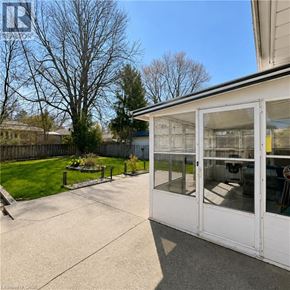 London apartment for rent - A sunny day with a white house and a glass door.