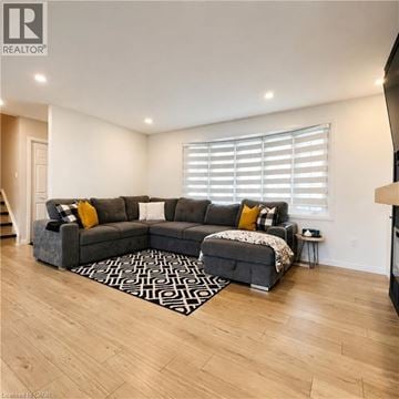 London apartment for rent - A living room with a grey sectional sofa and a patterned rug.