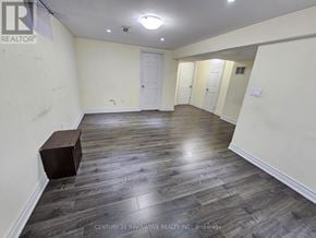 Toronto (Rouge) apartment for rent - A room with wooden flooring and white walls, with a wooden box on the floor.