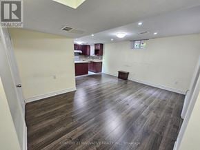 Toronto (Rouge) apartment for rent - A spacious room with wooden flooring and white walls.