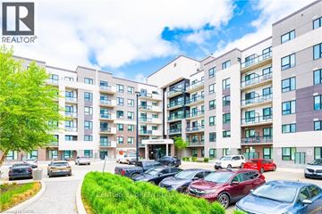 Milton (Fo Ford) condo for rent - A large apartment complex with cars parked in front.