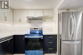 Toronto (Dorset Park) apartment for rent - A modern kitchen with a stainless steel refrigerator and a built-in oven.