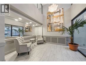 North Vancouver apartment for rent - A realtor office with a white chair and a brown table.