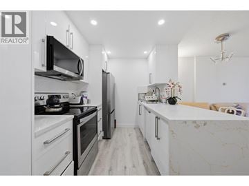 North Vancouver apartment for rent - A modern kitchen with a marble countertop and stainless steel appliances.