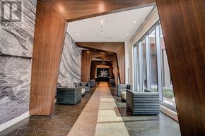 Toronto (Church-Yonge Corridor) condo for rent - A hallway with a marble floor and a checkered runner, leading to a staircase.