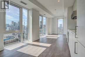Toronto (Church-Yonge Corridor) condo for rent - A spacious living room with a view of the city skyline.