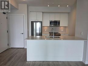 Mississauga (City Centre) condo for rent - A kitchen with white cabinets and a stainless steel refrigerator.