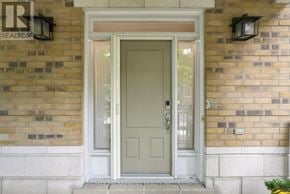Mississauga (Port Credit) townhouse for rent - A white door is set in a brick wall.