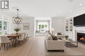 Mississauga (Port Credit) townhouse for rent - A modern living room with a fireplace and a dining table.