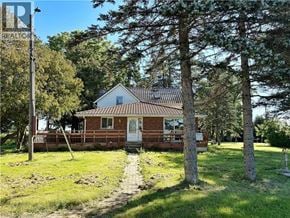 Waterford apartment for rent - A house with a red brick exterior and a white door is surrounded by trees.