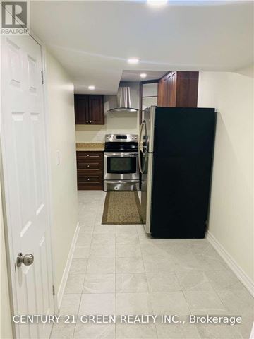 Milton (Fo Ford) apartment for rent - A kitchen with a black refrigerator and white walls.