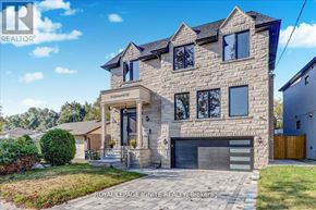 Toronto (Don Valley Village) apartment for rent - A large, modern house with a stone facade and a garage is for sale.