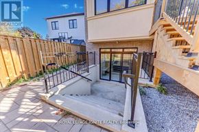 Toronto (Don Valley Village) apartment for rent - A modern house with a glass door and a wooden fence.