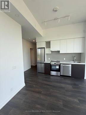 Vaughan (Steeles West Industrial) condo for rent - A modern kitchen with dark wood floors and stainless steel appliances.