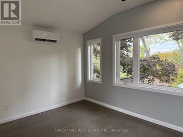 Ramara apartment for rent - A room with a window and a wall-mounted air conditioner unit.