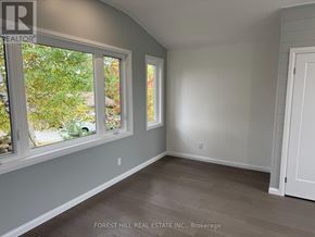 Ramara apartment for rent - A room with a large window and a door.