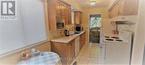Oakville (Cp College Park) apartment for rent - A kitchen with wooden cabinets and white appliances.