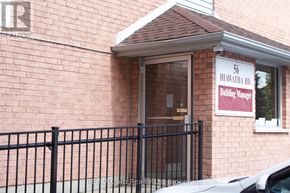 Woodstock (Woodstock - North) condo for rent - A building manager sign is posted on the front of a brick building.