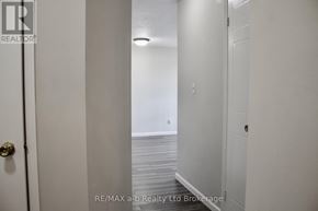 Woodstock (Woodstock - North) condo for rent - A hallway with a door on the left and a light on the ceiling.