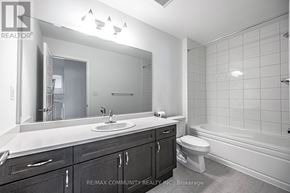 Pickering duplex for rent - A bathroom with a sink, toilet, and bathtub.