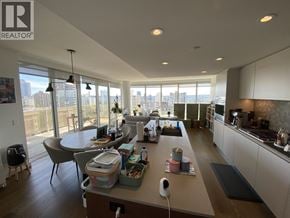 Vancouver apartment for rent - A modern kitchen with a large island and a view of the city.