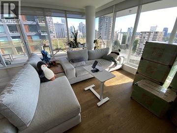 Vancouver apartment for rent - A living room with a grey sofa and a white coffee table.