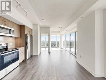 Toronto (Humber Heights) condo for rent - A spacious kitchen with wooden cabinets and a large island.