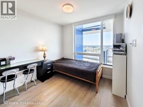 Vancouver apartment for rent - A bedroom with a bed, desk, and chair.