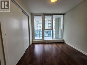 Richmond apartment for rent - A room with wooden floors and a sliding glass door leading to a balcony.