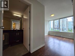 Richmond apartment for rent - A room with a wooden floor and a large window overlooking a cityscape.