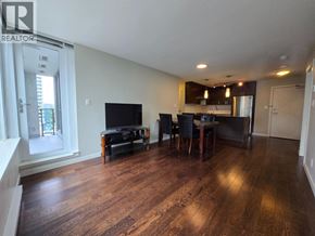 Richmond apartment for rent - A living room with a television, a couch, and a dining table.