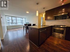 Richmond apartment for rent - A kitchen with dark wood floors and stainless steel appliances.