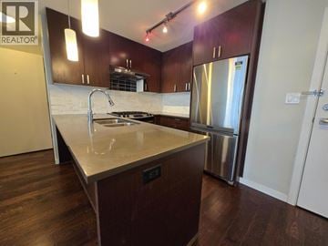 Richmond apartment for rent - A kitchen with a stainless steel refrigerator and a marble countertop.