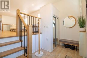 Brampton (Fletcher's Meadow) apartment for rent - A hallway with a mirror, a bench, and a staircase.