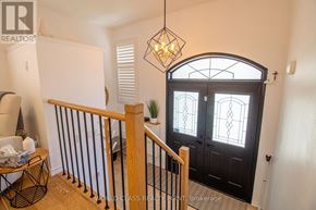 Brampton (Fletcher's Meadow) apartment for rent - A foyer with a black door and a wooden banister.