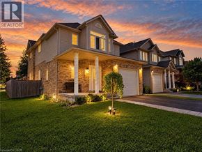 Waterloo apartment for rent - A house with a well-manicured lawn and a clear sky above.