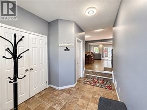 Waterloo apartment for rent - A hallway with a tree decoration on the left and a door on the right.