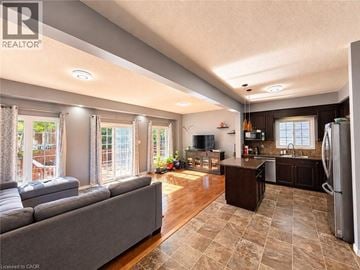Waterloo apartment for rent - A well-lit, spacious kitchen and living room with a grey sofa and wooden floors.