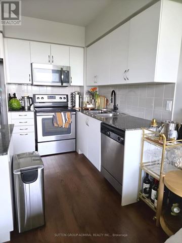 Toronto (Mimico) condo for rent - A kitchen with white cabinets and a stainless steel dishwasher.