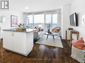Toronto (Mimico) condo for rent - A living room with a large island and a flat screen TV mounted on the wall.