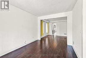 Whitby apartment for rent - A long hallway with wood floors and white walls.