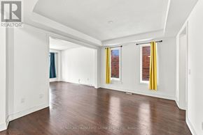 Whitby apartment for rent - A large, empty room with wooden floors and white walls.