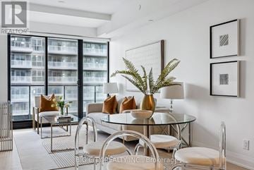 Toronto (Thorncliffe Park) condo for rent - A modern living room with a glass table and white chairs.