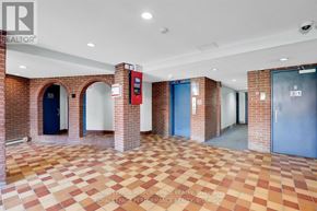 Ottawa condo for rent - A hallway with brick walls and tiled floors.