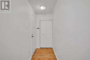 Ottawa condo for rent - A white hallway with a door and a light on the ceiling.