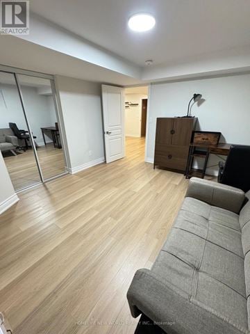 Markham (Box Grove) apartment for rent - A living room with a grey sofa and wooden flooring.