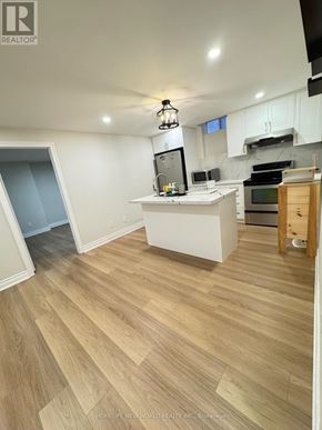 Markham (Box Grove) apartment for rent - A kitchen with a white counter and wooden flooring.