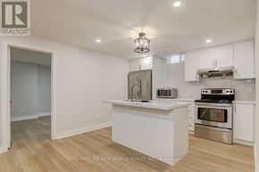 Markham (Box Grove) apartment for rent - A white kitchen with a stainless steel oven and microwave.