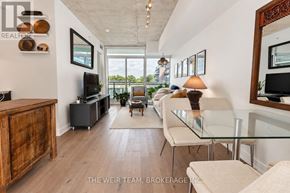Toronto (South Riverdale) condo for rent - A modern living room with a glass table and a television.