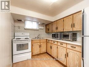 Toronto (Bendale) apartment for rent - A kitchen with wooden cabinets and white appliances.